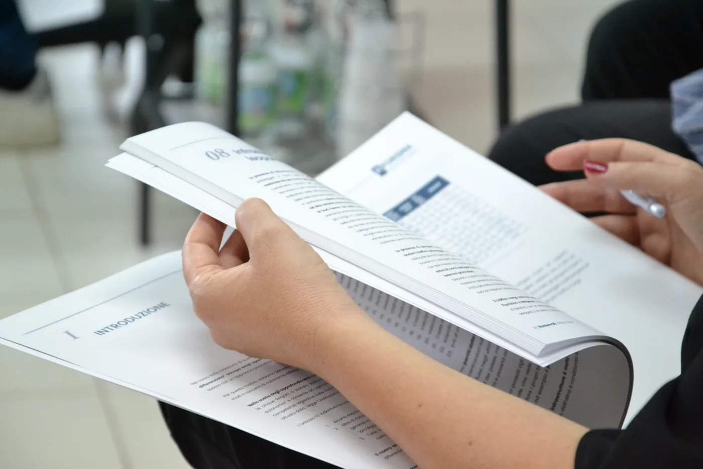A participant leafing through information material
